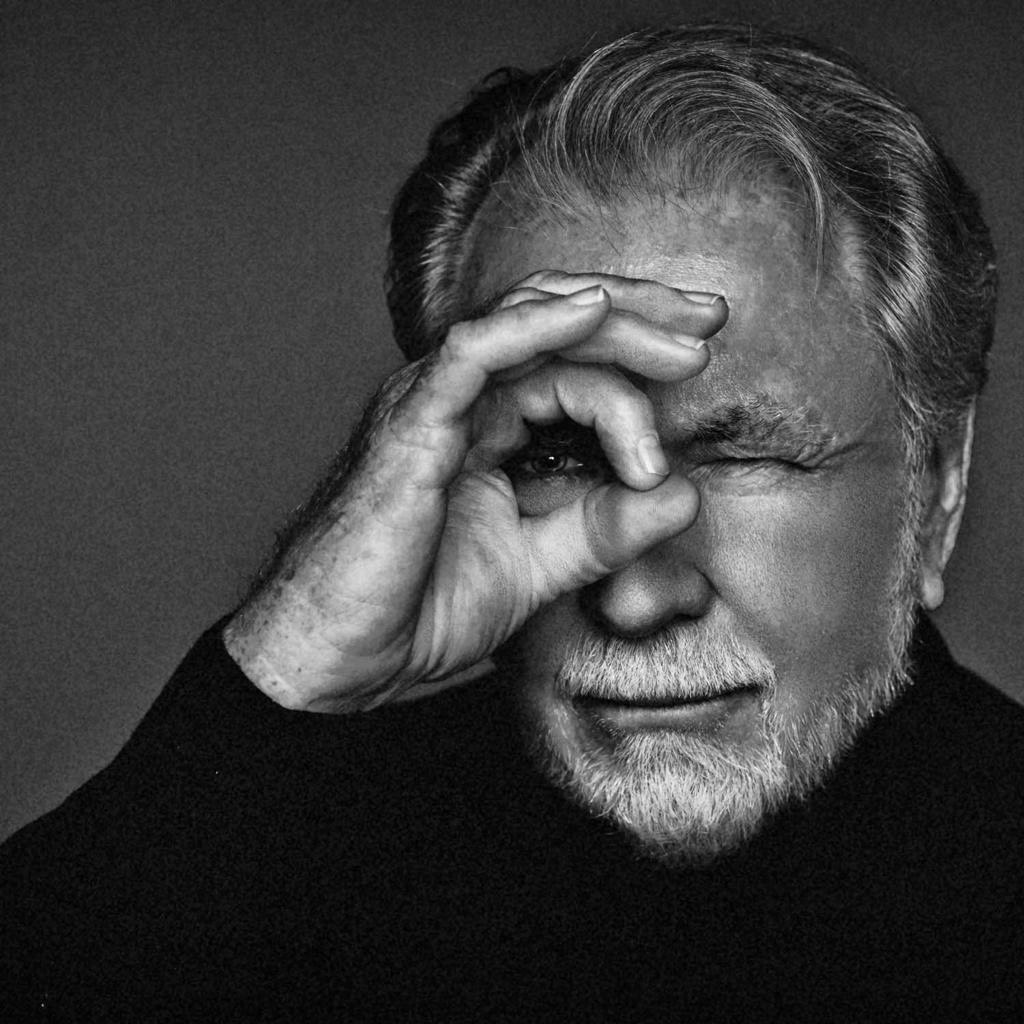 Black and white photo of Stephen Wayda making a circle with his ring finger and thumb