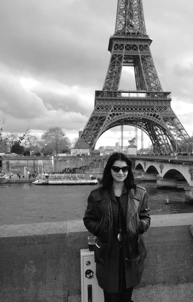 Goldie Moon standing in front of the Eiffel Tower.