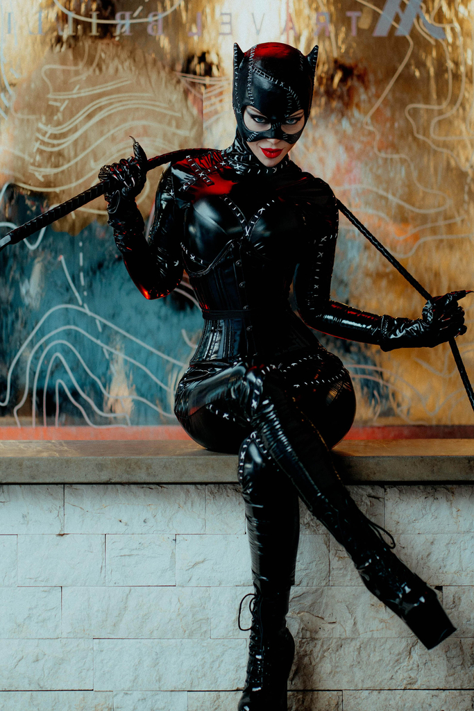 Darla Eliza cosplays as Catwoman with a whip.